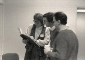 Three members standing and viewing a book at "the Blessing of the Office of Dignity/Central PA" - March 18, 1990