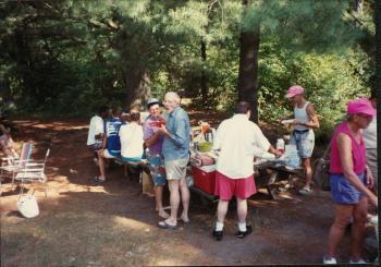 Members eating and making plates of food at the Dignity/Central PA 16th Anniversary Picnic - July 1991