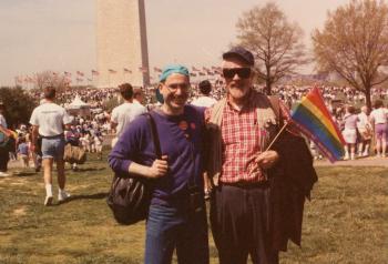 Up close view of Steven Leshner and person holding rainbow flag at event in Washington, D.C. - circa 1990