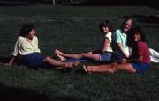 Friends sit in the grass, c.1982