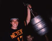 Two students hold a keg aloft, c.1983