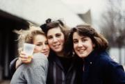 Three friends embrace, c.1985