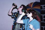 Pair shares a drink, c.1986