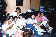 Friends sit with luggage, c.1987