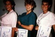 Three ladies pose with fake "chests", c.1990
