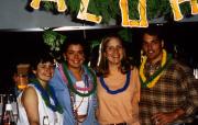 Four students smile at a luau party, c.1995