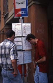 Two students check the bus schedule, 1996