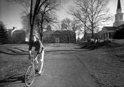 Student biking on Morgan Field, c.1985