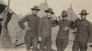 Four men in military uniforms, c.1920