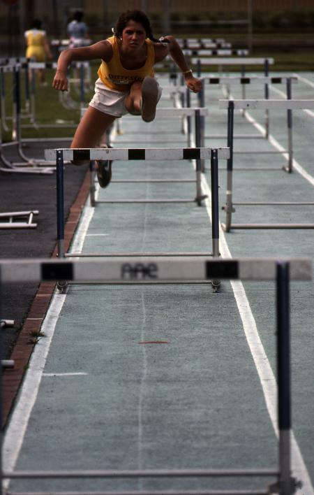 Student jumps a hurdle, c.1983