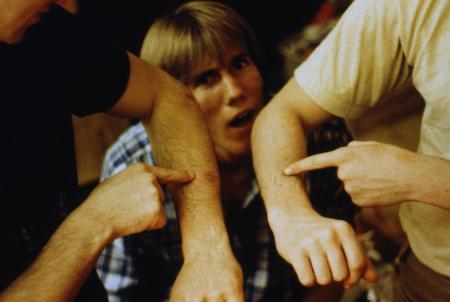 Students point to a spot on their arms, c.1983