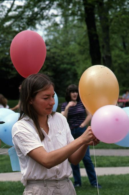 Ann Tihansky ties balloons together, c.1983
