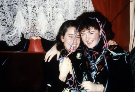 Two girls laugh with ribbon in their hair, c.1990