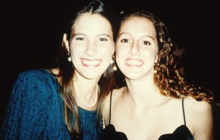 Two friends smile at a formal event, c.1995