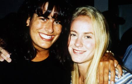 Two friends stand together and smile, c.1995