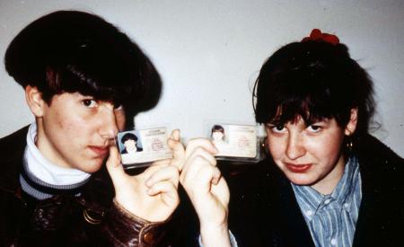 Two students hold their IDs, c.1995