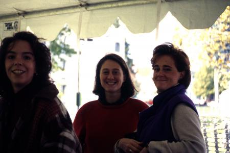 Three students stand under a tent, c.1996