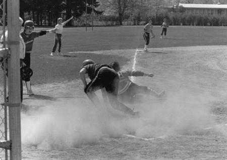 Softball player attempts to score, 1987