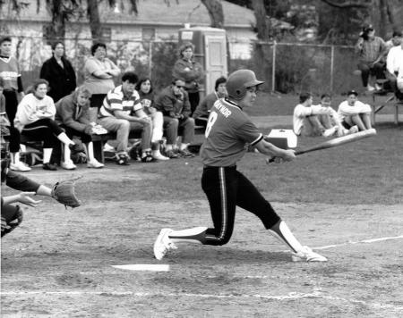 Softball player swings, c.1990