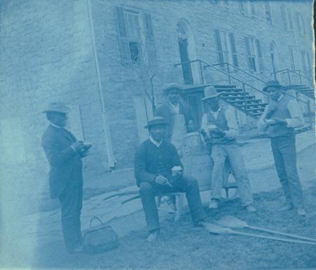 Janitors in front of East College, c.1890