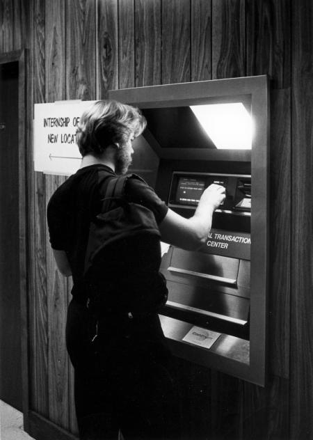 Student uses an ATM in the HUB, c.1985