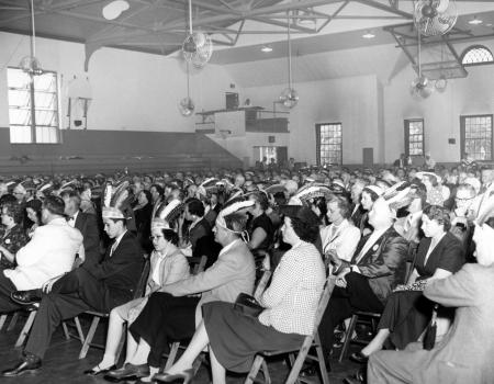 Class of 1930 wearing feathered hats, 1955