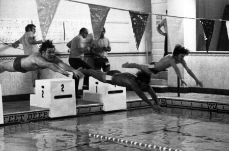 Swimmers dive into the pool, c.1980