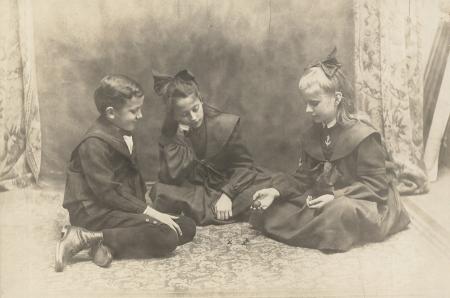 Morgan children playing jacks, c.1905