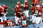 Football team gathers after a play, c.1990