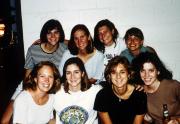 Eight students take a picture at an event, c.1995