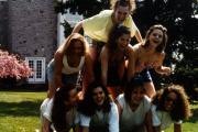 Girls make a pyramid on Morgan field, c.1995