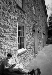 Student studying outside East College, 1983