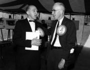 Two alumni chatting under the tent