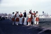 Cheerleaders chatting at a game, 1958