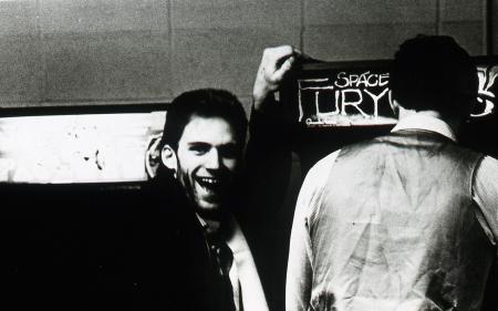 Student laughs while his friend Space Fury, c.1983