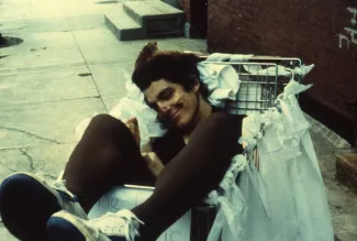 Student sits in a shopping cart, c.1985