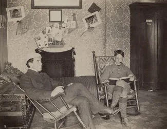 Two students in rocking chairs, c.1900