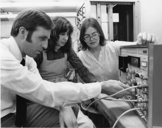 Physics professors and student with science equipment, 1979